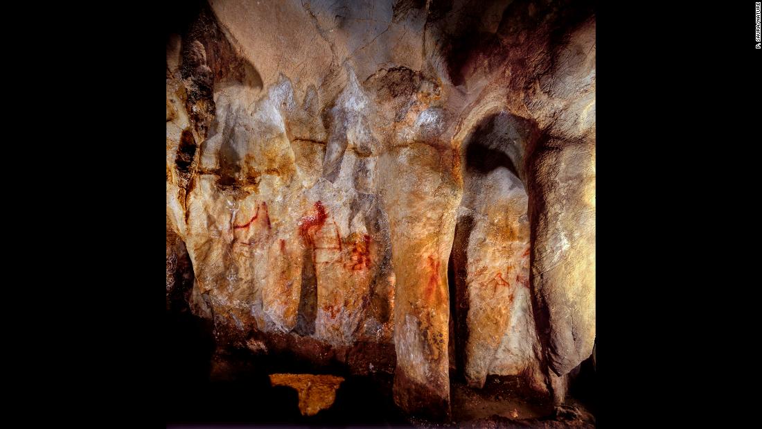 This wall with paintings is in the La Pasiega Cave in Spain. The ladder shape of red horizontal and vertical lines is more than 64,000 years old and was made by Neanderthals.