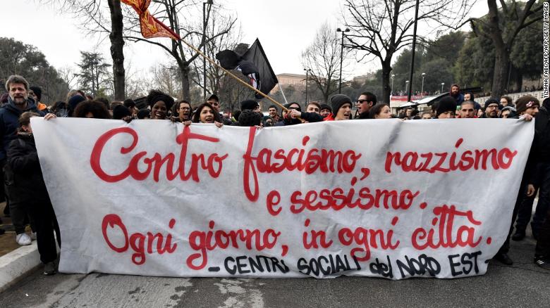 Italian demonstrators hold a banner reading &quot;against fascism, racism and sexism.&quot; Right wing, anti immigrant parties recently took power in Italy.