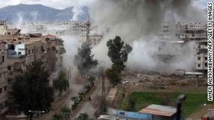 Smoke billows following strikes on Kafr Batna, in the Eastern Ghouta region, on Thursday.