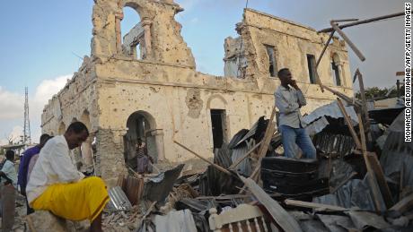 Residents survey remains after bombings in Mogadishu.