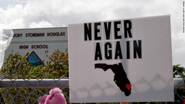 Memorials are seen on a fence surrounding Marjory Stoneman Douglas High School in Parkland, Florida on February 21, 2018. 