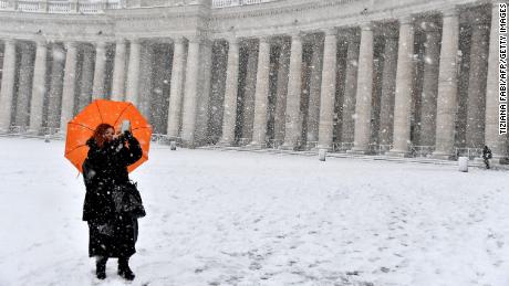 A woman braves freezing conditions at St. Peter&#39;s Square.  