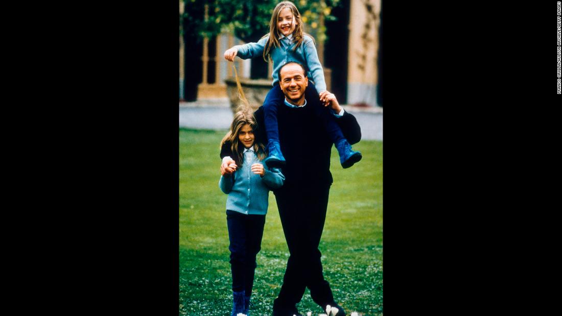 Berlusconi plays with daughters Barbara, left, and Eleonora in Milan.