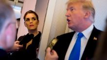 President Donald Trump, accompanied by President Donald Trump's White House Communications Director Hope Hicks, second from left, speaks to reporters aboard Air Force One at Ninoy-Aquino International Airport in Manila, Philippines, Tuesday, Nov. 14, 2017, before traveling to Hickam Air Force Base, Hawaii and then on to Washington. 