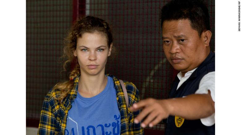 A police officer escorts Anastasia Vashukevich from a detention center in Pattaya, south of Bangkok, Thailand, Wednesday, Feb. 28, 2018, after she was arrested Sunday in the Thai resort city of Pattaya while giving sex lessons to Russian tourists.