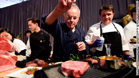 Master chef Wolfgang Puck (center) makes it rain salt on a Miyazaki Wagyu beef, with chef Eric Klein (right) looking on during 90th Annual Academy Awards Governors Ball Press Preview in Hollywood, California, March 1, 2018. 