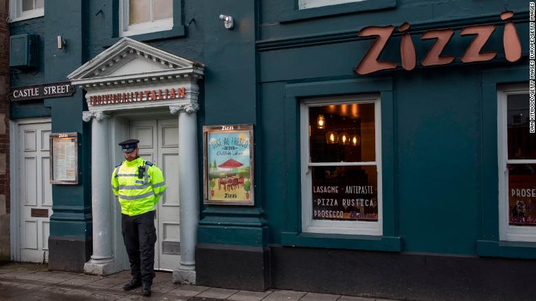 A police officer stands outside Zizzi Restaurant in the Salisbury town center, close to where a man and woman, belived to be Skripal and his daughter, had been found unconscious two days previously.