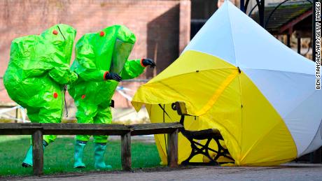 Emergency services in biohazard suits work at the bench where the Skripals were found on March 4, 2018.