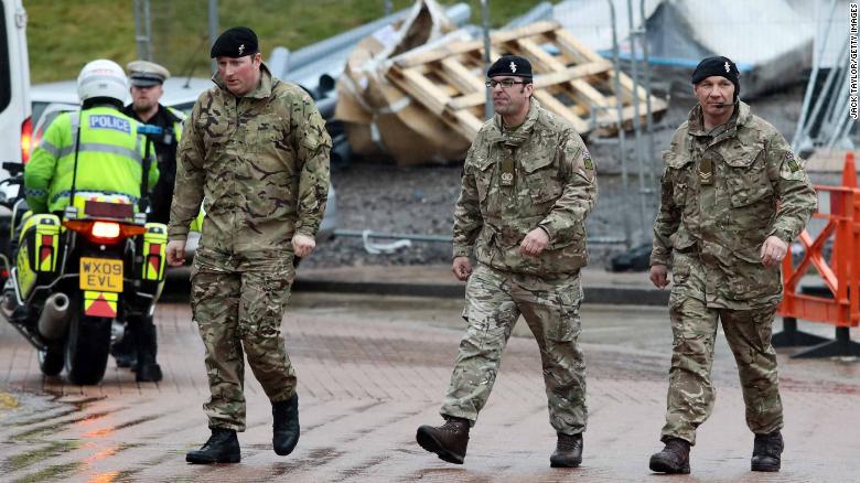 Military personnel are seen outside Salisbury District Hospital, Sunday.