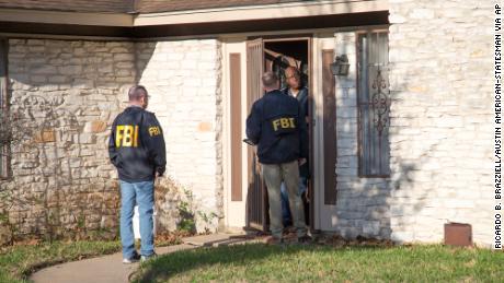 Authorities are investigating the scene in East Austin, Texas, after a teenager was killed and a woman was injured in the second Austin package explosion in the past two weeks Monday, March 12, 2018. Authorities say a package that exploded inside of an Austin home on Monday is believed to be linked to a deadly package sent to another home in Texas&#39; capital city earlier this month. (Ricardo B. Brazziell/Austin American-Statesman via AP)