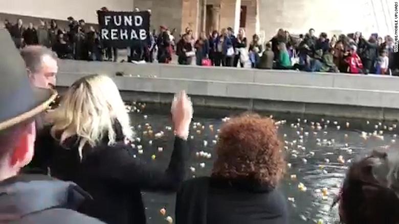 Protesters throw pill bottles in famous museum