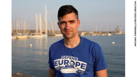 Martin Sellner, the leader of Generation Identity, poses in the harbor of Catania, Italy, in July.