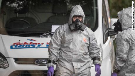 Investigators in protective clothing remove a van from an address in Winterslow near Salisbury.