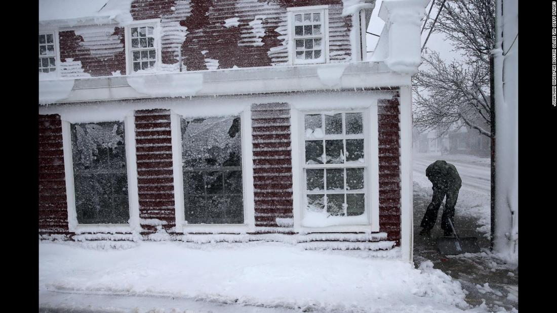 Cole Stiles clears a sidewalk in Scituate, Massachusetts, on March 13.