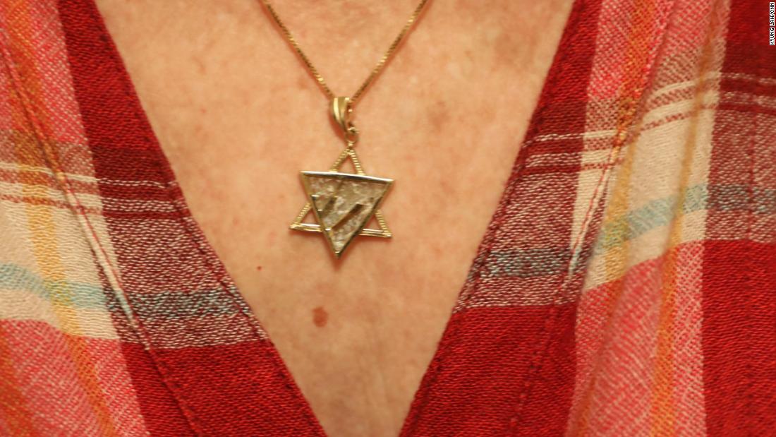 The woman wears a Star of David pendant. To her, the Holocaust is a permanent reminder that people could be kicked out of a country they thought was home.