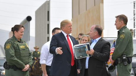 US President Donald Trump (C) is shown border wall prototypes in San Diego, California on March 13, 2018. / AFP PHOTO / MANDEL NGAN        (Photo credit should read MANDEL NGAN/AFP/Getty Images)