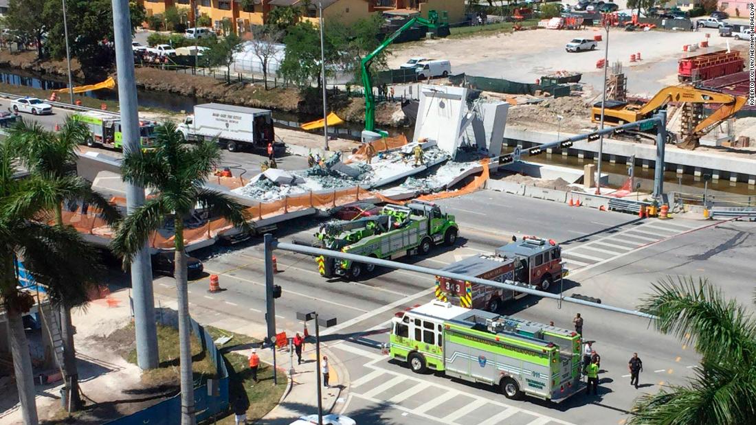 Emergency personnel respond to the scene of a deadly bridge collapse in Miami on Thursday, March 15. The bridge was installed Saturday at Florida International University.