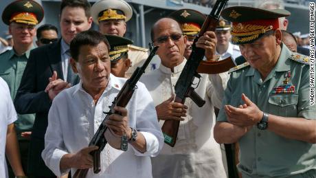 Philippine President Rodrigo Duterte, front left, with Russia&#39;s Defence Minister Sergei Shoigu, right,  after the delivery of Russian arms to the Southeast Asian nation. 