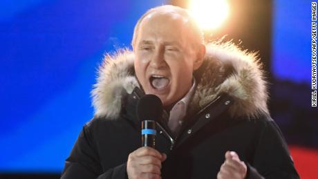 Putin addresses the crowd during Sunday night&#39;s rally and concert in Moscow.