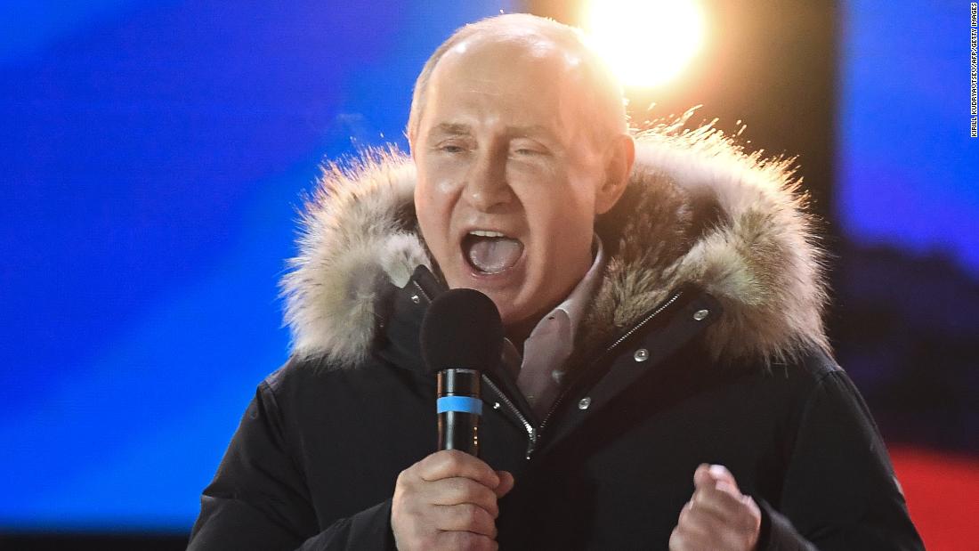 Putin addresses the crowd during a rally and concert in Moscow on Sunday night. 