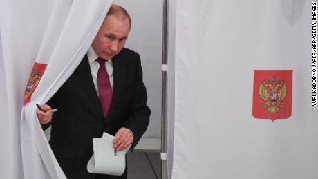 Presidential candidate, President Vladimir Putin walks out of a voting booth at a polling station during Russia&#39;s presidential election in Moscow on March 18, 2018. / AFP PHOTO / POOL / Yuri KADOBNOV        (Photo credit should read YURI KADOBNOV/AFP/Getty Images)