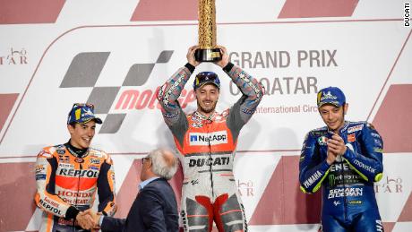 Andreas Dovizioso (center) celebrates alongside Marc Marquez (left) and Valentino Rossi.