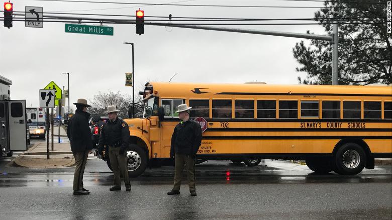 School buses were used to transport students to a nearby school to be reunited with their parents.