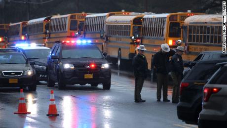 School buses lined up in front of Great Mills High School after a shooting on Tuesday to transport students to another school.