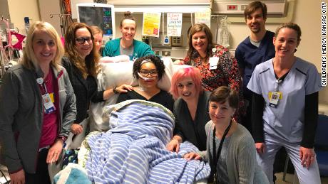 Zei Uwadia with her mother and medical team at Children's Mercy Kansas City. Clockwise from left are Kari Davidson, Dr. Jenna Miller, Ryanne Toland, Julie Pearson, Debbie Newton, Dr. Jay Rilinger, Jill Dinkel, Dr. Marita Thompson and Zei's mother, Brie Kerschen.