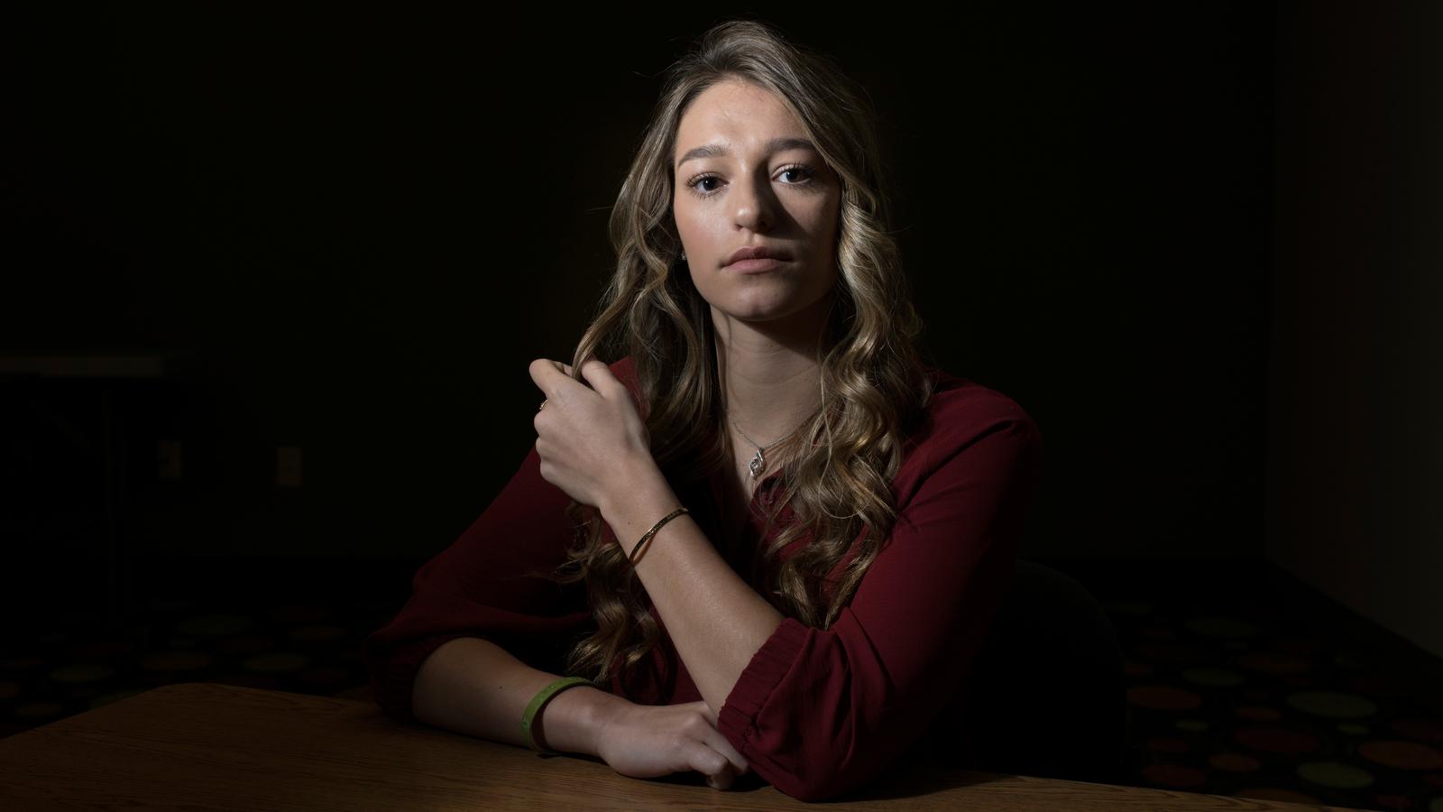 Izzy Hutchins, 19, said training at John Geddert’s gym was the “darkest time” of her life. Her mother, Lisa, gave her the metal bracelet seen on her left arm shortly before Izzy spoke at Nassar’s sentencing. The inscription reads, “She believed she could, so she did.”