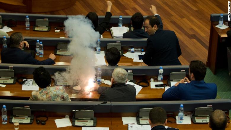 Opposition lawmakers ignite a tear gas canister, disrupting a parliamentary session in Pristina on Wednesday.