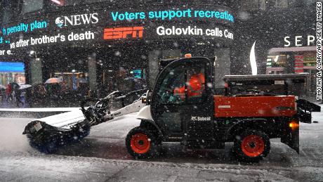 Workers in New York&#39;s Times Square battle the fourth nor&#39;easter in a month Wednesday.