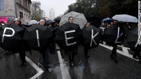Women march holding umbrellas, a symbol of their protest against proposed abortion restrictions, in Warsaw in October 2017. 