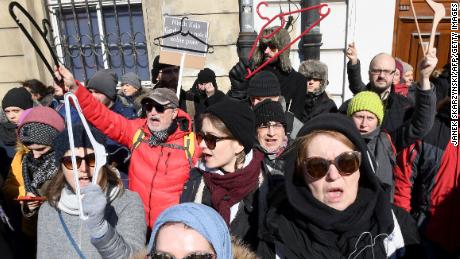 People hold up coat hangers as they demonstrate in front of the seat of the Warsaw archdiocese on March 18, 2018 in a protest against what they call the Catholic Churchs intrusion into politics by supporting a new measure to tighten the already restrictive law on abortion. / AFP PHOTO / JANEK SKARZYNSKI        (Photo credit should read JANEK SKARZYNSKI/AFP/Getty Images)