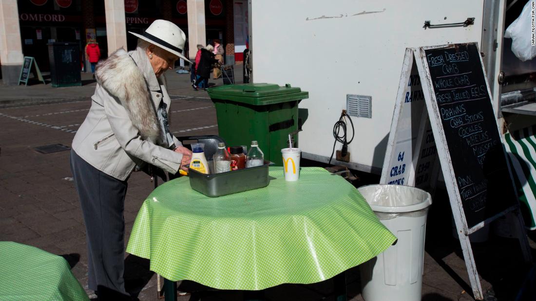 A customer uses condiments outside Crosbie&#39;s The Better Plaice seafood stall.