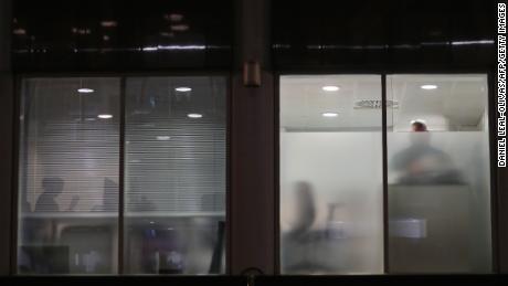 People are seen Friday in Cambridge Analytica&#39;s London offices after a search warrant&#39;s approval. 
