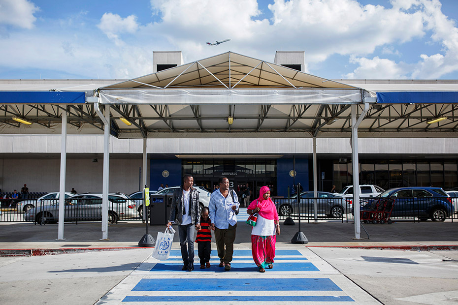 Abdalla, Habibo and their youngest son, Ibrahim, walk with Ramadhan outside the Atlanta airport after reuniting with him there in July. (Melissa Golden/Redux for CNN)