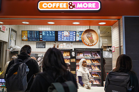 Batulo serves drinks to customers at the airport Dunkin&#39; Donuts. Occasionally, she helps lost passengers find their way. (Melissa Golden/Redux for CNN)