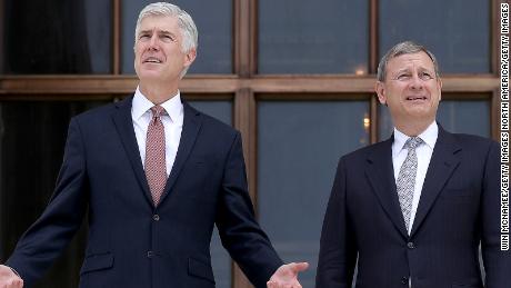 WASHINGTON, DC - JUNE 15: Supreme Court Justice Neil Gorsuch (L) talks with Chief Justice John Roberts (R) on the steps of the Supreme Court following his official investiture at the Supreme Court June 15, 2017 in Washington, DC. Gorsuch has been an active member of the court since his confirmation though the official investiture ceremony was held today. (Photo by Win McNamee/Getty Images)