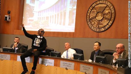 Mayor Darrell Steinberg, center, looks on as Stevante Clark leads a protest earlier this year.