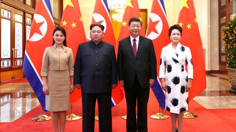 Chinese President Xi Jinping, second from right, and his wife, Peng Liyuan, right, and North Korean leader Kim Jong Un, second from left, and his wife, Ri Sol Ju, left, pose for a photo at the Great Hall of the People in Beijing. 