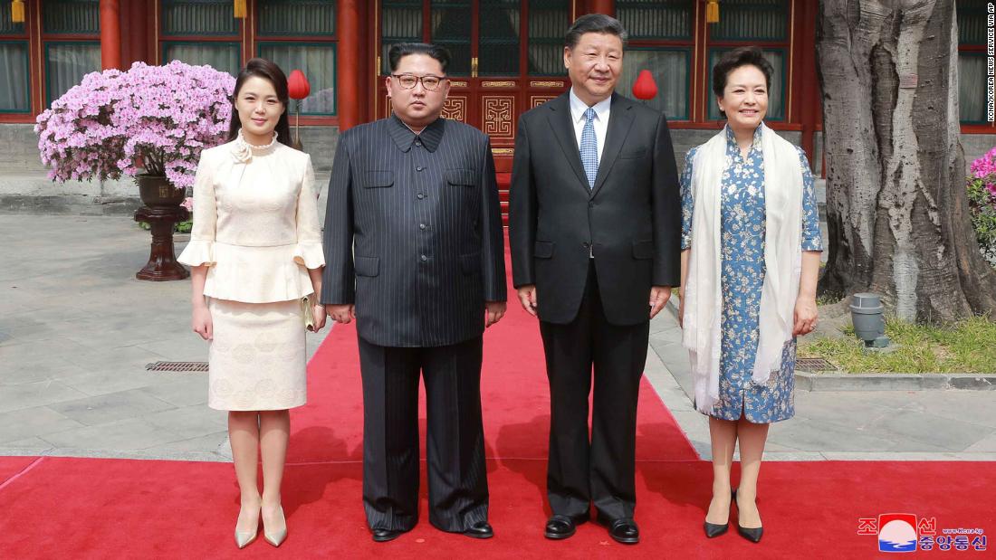 North Korean leader Kim Jong Un, his wife Ri Sol Ju, Xi Jinping and his wife Peng Liyuan pose for a photo at Diaoyutai State Guesthouse in Beijing.