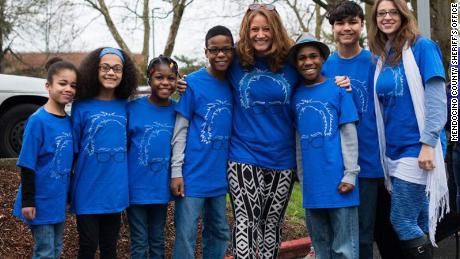 Jennifer and Sarah Hart adopted two sets of siblings. Hannah stands on the far left.