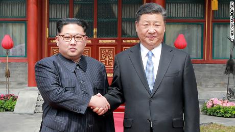 A photograph from North Korea&#39;s official Korean Central News Agency (KCNA) released on March 28, 2018 shows China&#39;s President Xi Jinping (right) shaking hands with North Korean leader Kim Jong Un in Beijing.