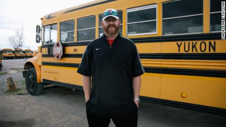 Math teacher Jonathan Moy also drives a school bus, his second job of the day. Afterward, he&#39;ll umpire two baseball games.