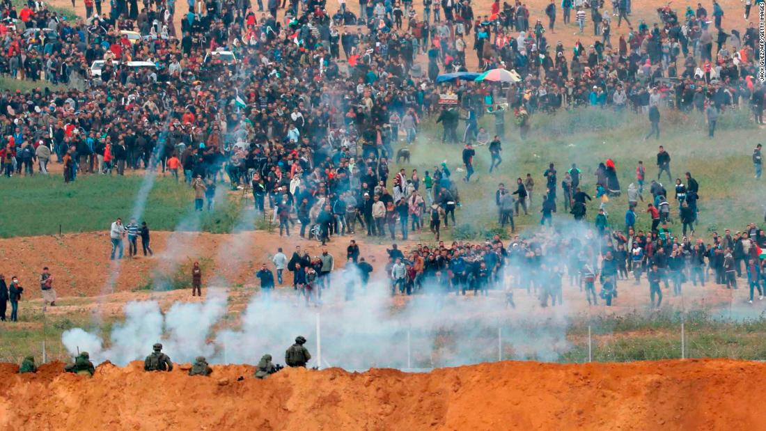 Israeli forces fire tear gas towards Palestinian protesters at the Gaza border fence Friday. 