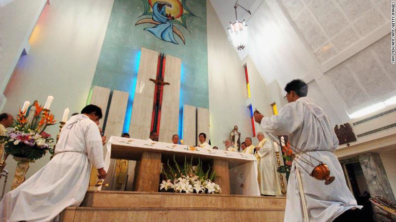 Taiwanese Catholic priests pray for the late Pope John Paul II during a service in Taipei, April 3, 2005. 