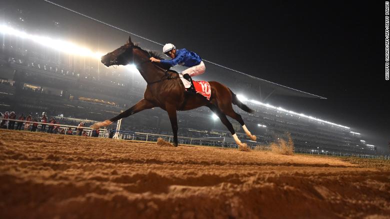Jockey Christophe Soumillon rides Thunder Snow across the finish line to win the Dubai World Cup horse race at the Dubai World Cup in the Meydan Racecourse on March 31, 2018 in Dubai. / AFP PHOTO / GIUSEPPE CACACE        (Photo credit should read GIUSEPPE CACACE/AFP/Getty Images)