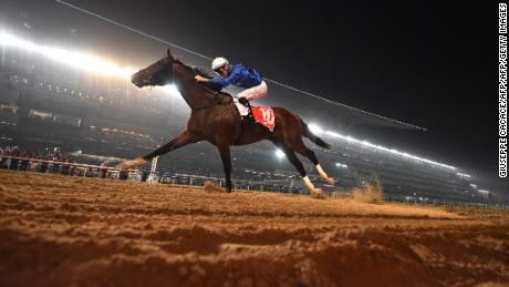 Jockey Christophe Soumillon rides Thunder Snow across the finish line to win the Dubai World Cup horse race at the Dubai World Cup in the Meydan Racecourse on March 31, 2018 in Dubai. / AFP PHOTO / GIUSEPPE CACACE        (Photo credit should read GIUSEPPE CACACE/AFP/Getty Images)