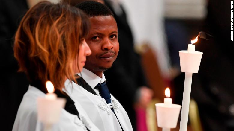 Migrant John Ogah looks on after being baptized by Pope Francis during the Easter Vigil at St. Peter's Basilica.